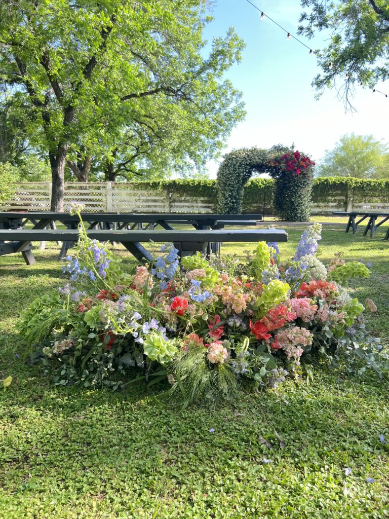 Floral Decor at Farm at South Mountain, with floral arch in the background